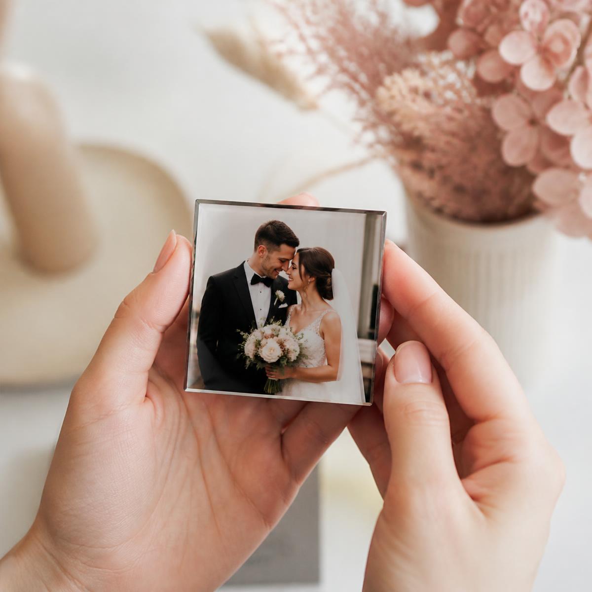 Hands holding a wedding photograph magnet